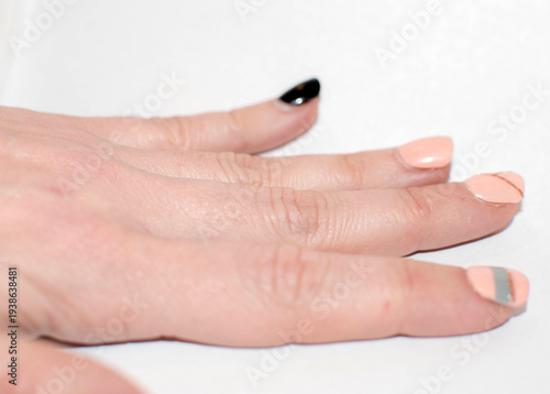 Hand with Nude and Black Nails Featuring Minimalist Art