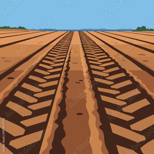 Tractor tire tracks on dirt field under blue sky  