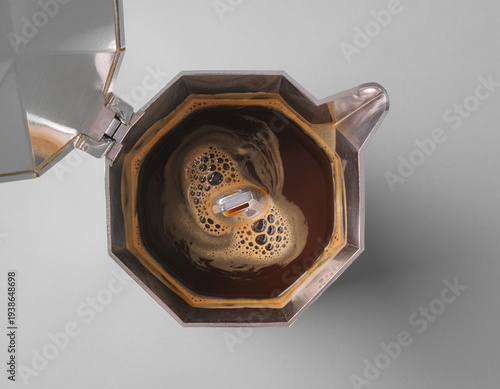 Freshly brewed coffee in italian moka pot seen from above