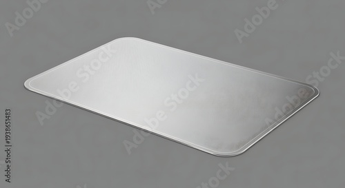 Silver metal tray with rounded corners and edges on gray background for food presentation or serving