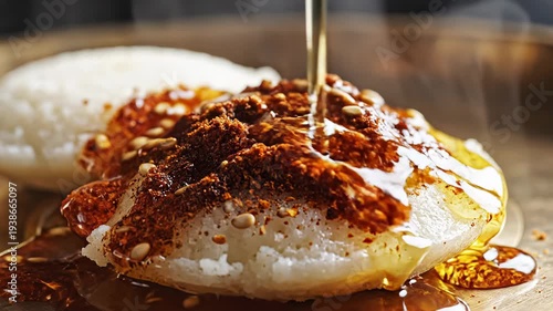 Steaming Hot Savory Rice Cakes Topped with Chili Paste and Sesame Seeds Drizzled with Oil in a Rustic Wooden Bowl Close Up Appetizing Food Photography