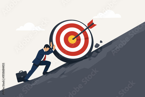 Businessman pushing a large target with an arrow in the bullseye up a steep hill, representing the struggle to achieve goals, business challenges, hard work, ambition, and perseverance concept.