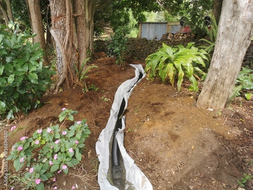 Installing a French drain in garden for better rainwater flow