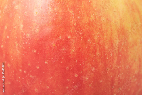 Yellow with red apple as background. Apple skin macro photo.