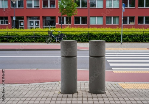 Two concrete bollards on a sidewalk