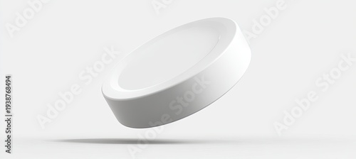 A minimalist white round object floats on a light gray background