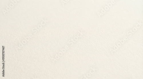 Soft ivory paper texture background with fine grain and warm off-white tones, clean minimal surface ideal for premium stationery luxury brand or elegant corporate design