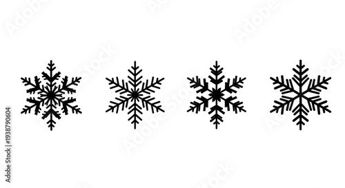 Collection of four intricate black snowflakes isolated on white background representing winter frost and cold season