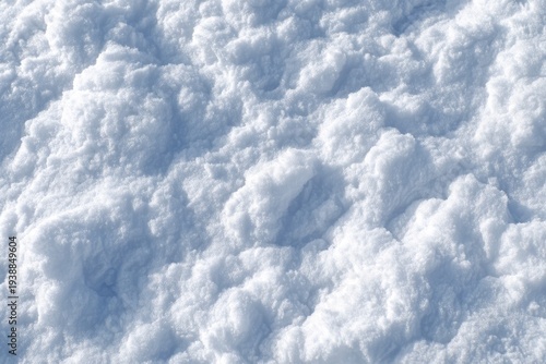 Abstract Close-up of Fresh White Snow Texture with Soft Blue Shadows, Granular Surface, and Irregular Lumps.