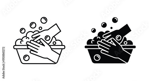 A hand washing a bottle in a bucket with soap bubbles in black and white