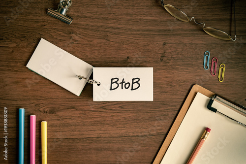 Corporate and management concept of BtoB represented on word card with clipboard, pen, glasses. Professional business leadership and operations.