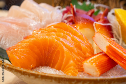 Foto Assorted mixed sashimi set on ice with salmon, hokkigai clam, hamachi, and tamag