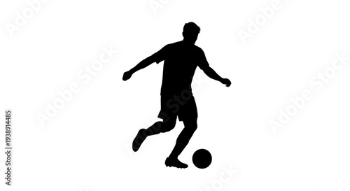 Silhouette of Soccer Player Kicking Ball.