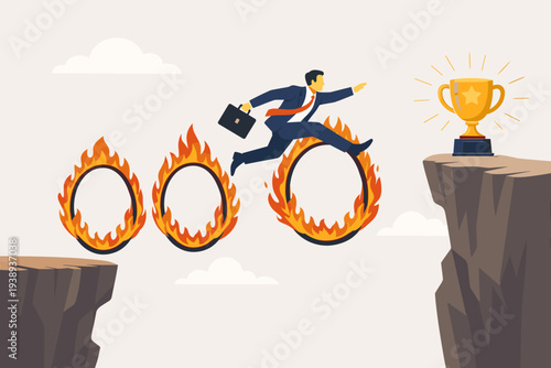 Ambitious businessman in a suit jumping through flaming hoops over a cliff gap to reach a golden trophy, representing business challenge, overcoming obstacles, risk management, and career success