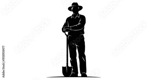 Man in hat standing with shovel in hand confidently