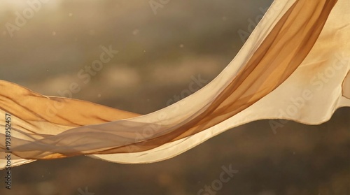 Close-up of a flowing, wavy fabric with warm beige and brown hues against a blurred natural background with a shallow depth of field.