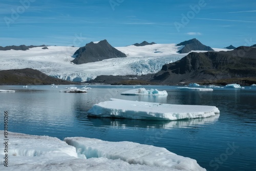 Glacial landscape with floating icebergs in a calm fjord under clear blue sky