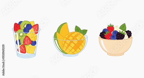 Fresh fruit mix in glass, sliced mango beside bowl of assorted berries on table