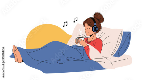 Relaxed young woman in bed listening to music with headphones while holding a steaming hot cup of coffee or tea in a cozy setting.