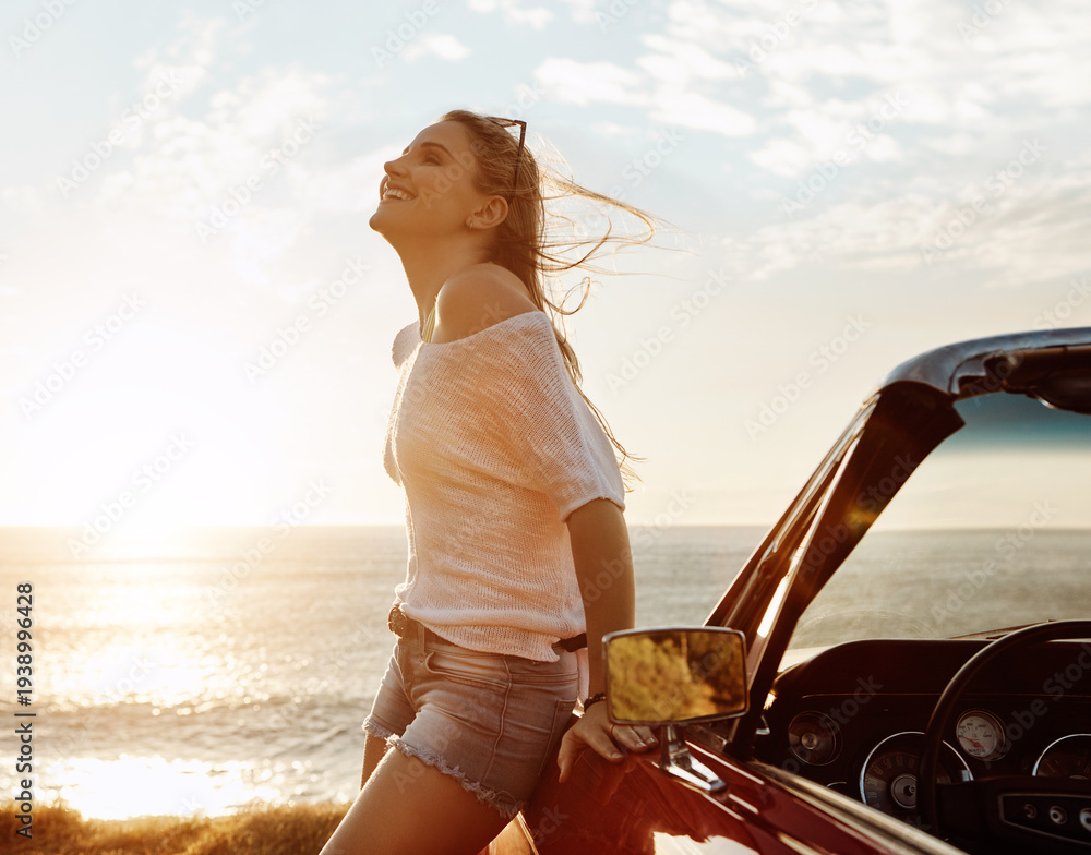 Obraz premium Ocean, road trip and woman by car at sunset for relax, vacation or weekend with outdoor break. Calm, sea water and female person by convertible vehicle for holiday, adventure or travel in summer.