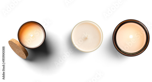 Tableau sur toile Top-down view of glowing scented candles in elegant glass and metal containers