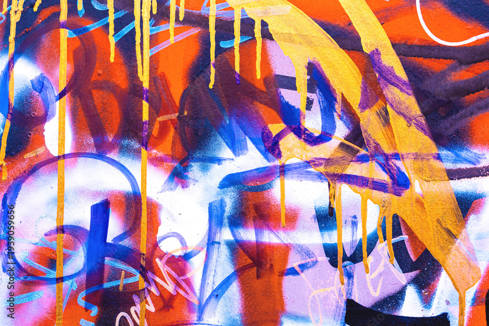 Obraz premium Abstract graffiti street art with bright orange, blue, yellow spray paint drips. 2000s urban style, neon colors, layered spray paint, vibrant composition. Posters, flyers, digital art, creative banner