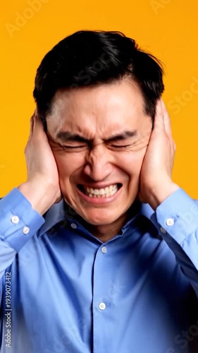 Wallpaper Mural Man Grimacing Covering Ears Loud Noise Torontodigital.ca