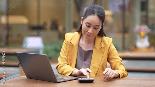 Female businessman working with smart phone and laptop and digital tablet computer.