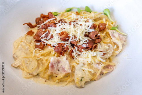 Die cut of Spaghetti carbonara with cheese and crispy bacon on white isolated.