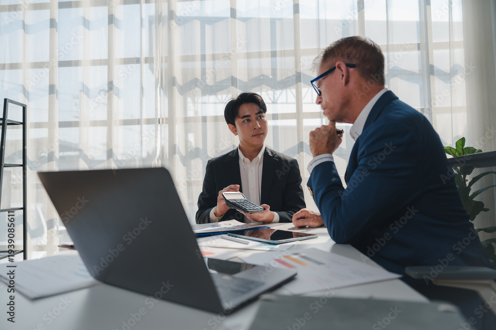 Fototapeta premium Young financial advisor discussing business plan with client