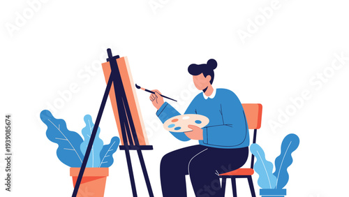 Creative female artist sits in a chair and focuses on painting a canvas set on a tall wooden easel inside a minimalist studio space.