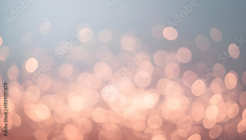 A soft and dreamy background with peach-colored bokeh lights against a blue gradient sky