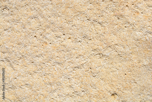 Foto A close up shot of a natural rough yellow limestone wall showing detailed porous