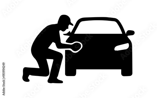Person silhouette cleaning a car with a rag, showing auto care