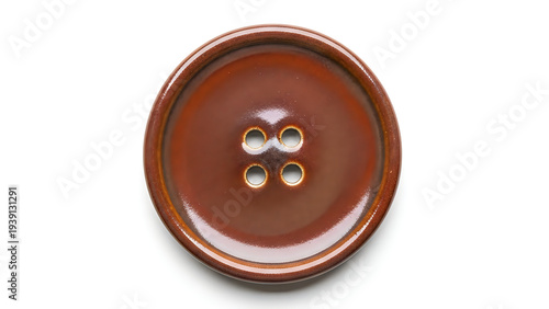 Brown plastic button with four holes on transparent background for sewing and crafting projects