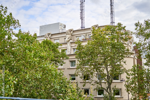 фотографія A beige residential building in Paris, France, featuring distinctive neoclassica
