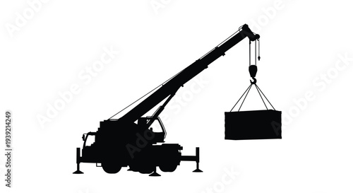 Black silhouette of a mobile construction crane lifting a heavy load