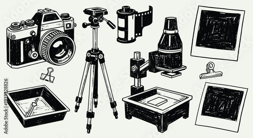 Vintage photography equipment including a camera tripod film developing trays and instant photos for analog photography enthusiasts