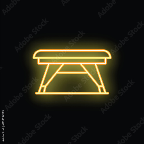 Neon sign representing a massage table glowing yellow against a black background