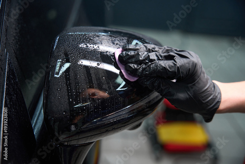 Fotografi Car detailing professional decontaminating paintwork on motor vehicle exterior