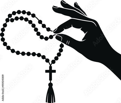 A hand holding a black rosary with a cross and tassel