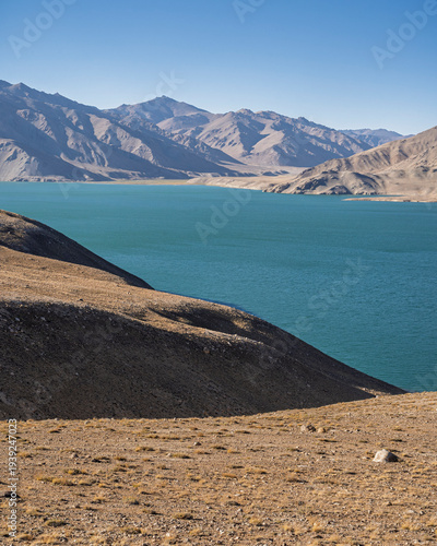 Vertical mountain landscape view of high-altitude Yashilkul lake aka Yashikul on bright summer day, Murghab, Gorno-Badakhshan, Tajikistan Pamir