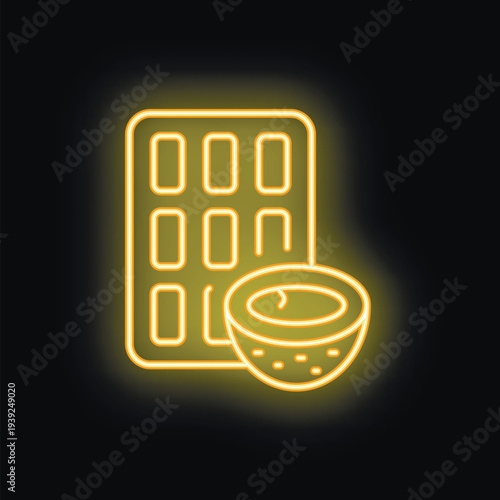 Yellow neon sign showing a chocolate bar and half of coconut representing vegan milk chocolate concept