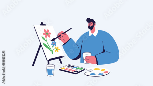 A man with a beard sits and happily paints flowers on an easel, engaging in a creative and relaxing artistic hobby.