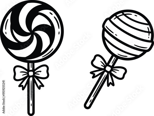 Two black and white lollipops with bows