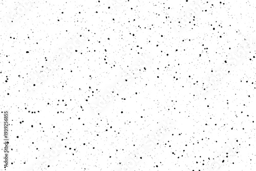 A striking black speckled dust pattern covers a pristine white surface creating a subtle distressed effect