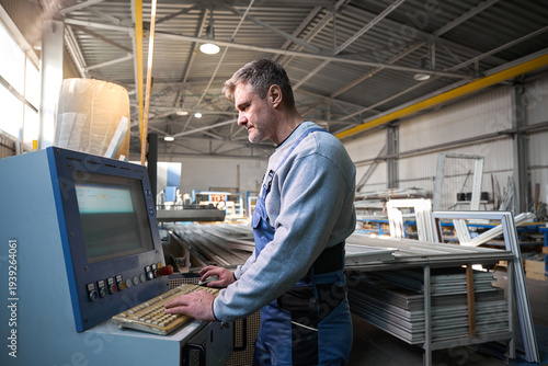 Manual worker assembling windows at factory