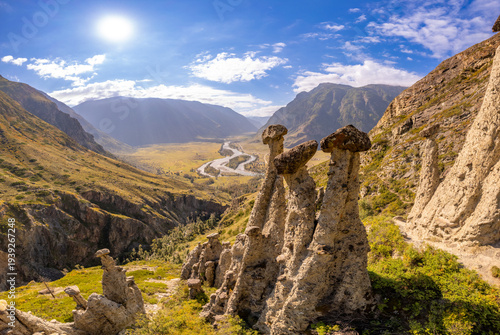 Aerial panaramic view to Natural formations stone mushrooms in Akkurum tract against blue sky, rock formations of a bizarre shape in sunny day. Ulagan Chulyshman river Valley, Altai Republic, Russia