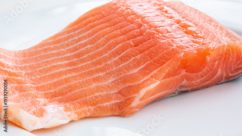 Salmon fillet captured up close in brilliant detail. The  bright orange juicy flesh fills the frame in a stunning way. Food inspired content.