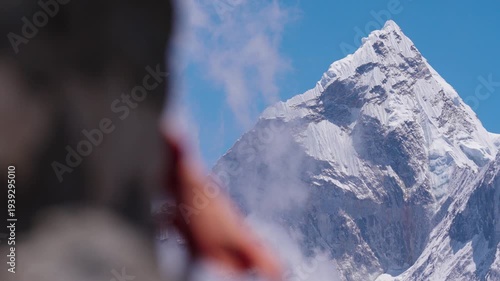 Stunning view of the iconic snow-covered Ama Dablam peak in Nepal, beautifully framed by colorful Tibetan prayer flags

